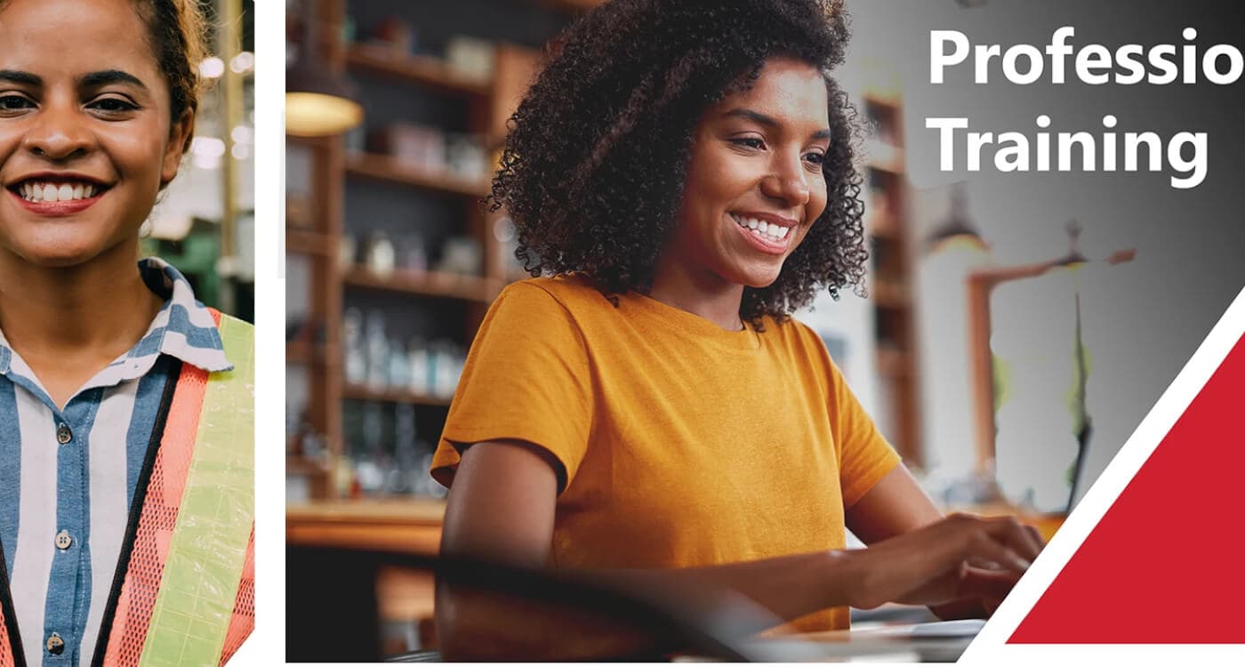 Stock Image of young woman smiling while typing at computer